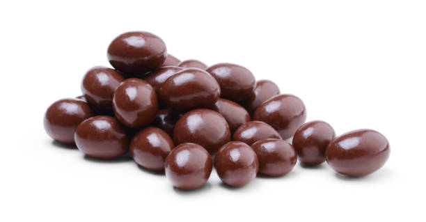 Heap of peanuts covered in chocolate isolated on white background